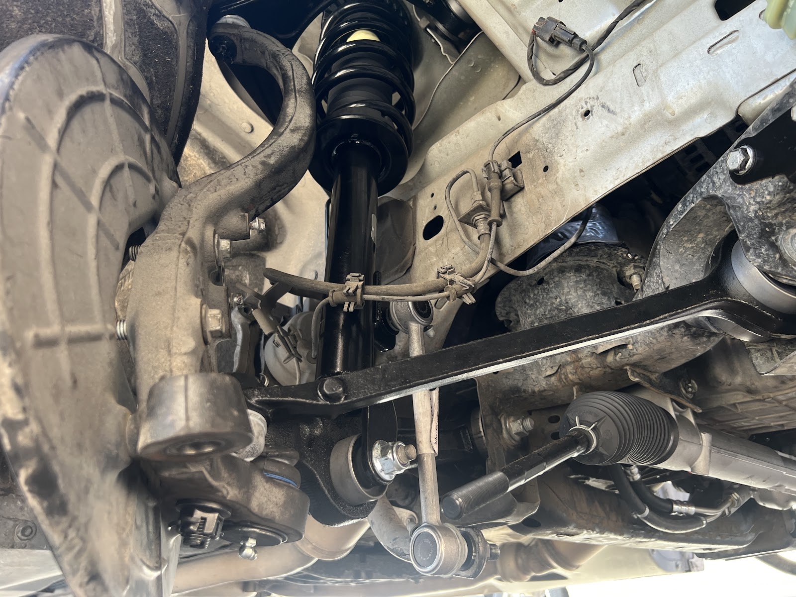 Brand new strut and coil spring installed, photographed from under the car